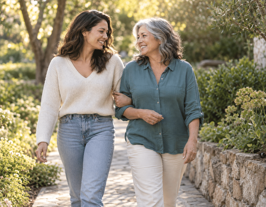 Adult daughter walking outdoors with her mother