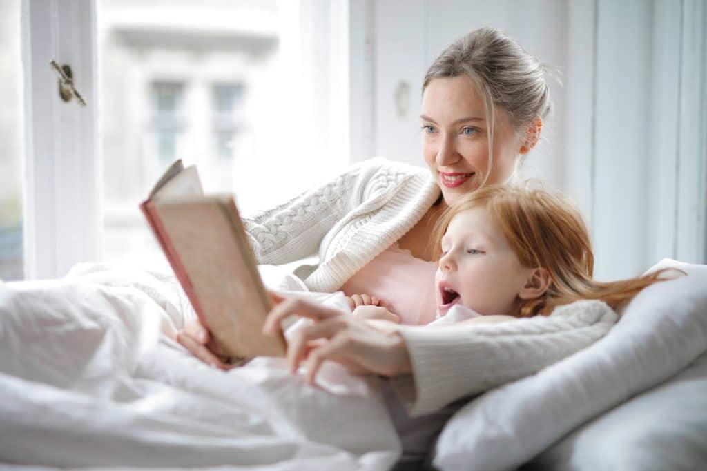 mother and daughter reading book with interest in bed 3755514 1024x682 - Night-time Routine Ideas