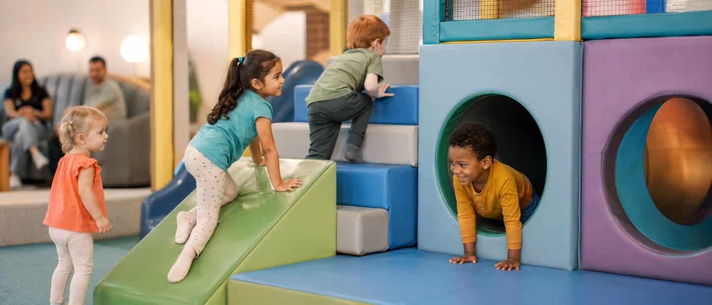 Children climbing and crawling at a soft play birthday party