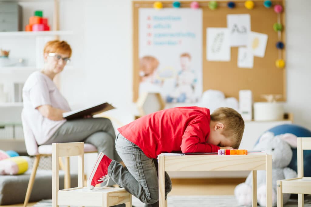 cute little boy with adhd during session with professional thera