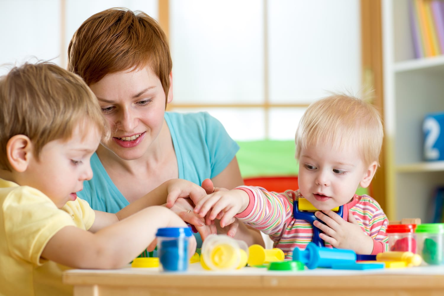 kids and mother playing colorful clay toy