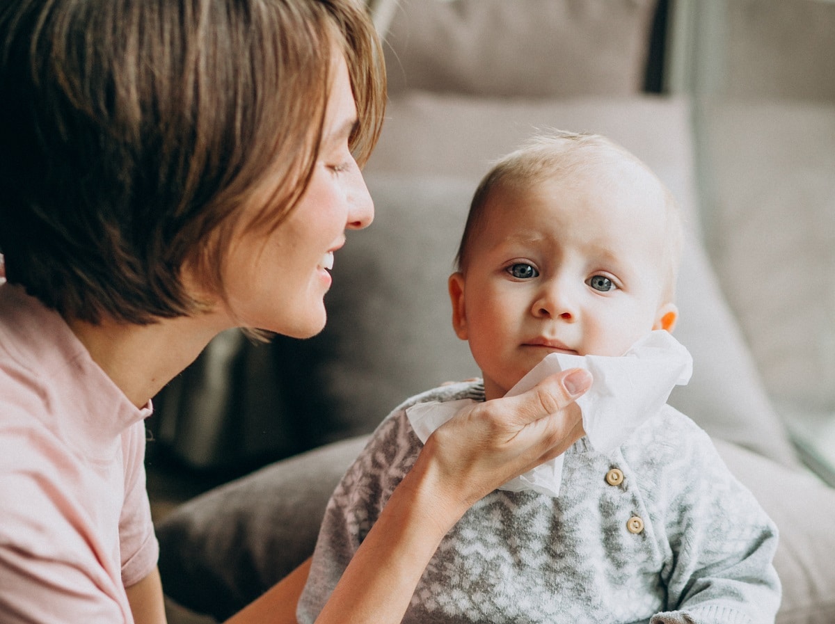 mother with her little son using napkins for runny nose