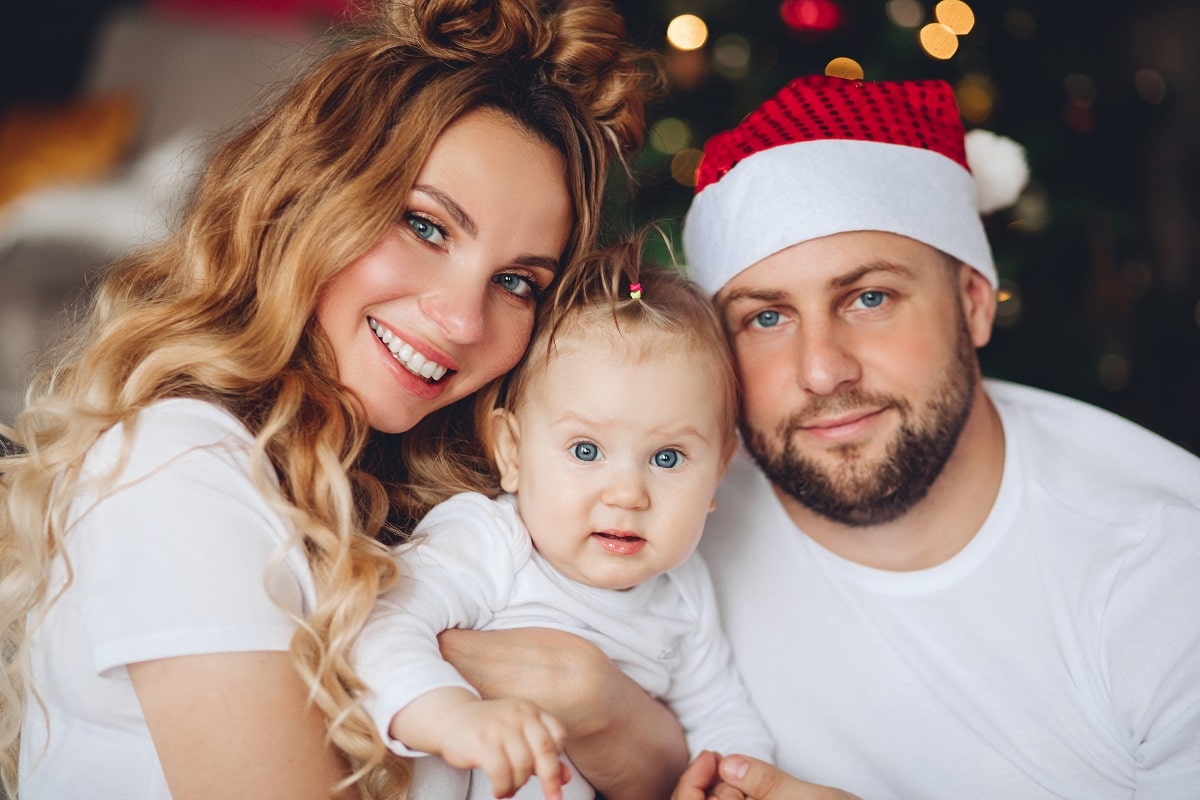 cute baby with parents at christmas. christmas time.