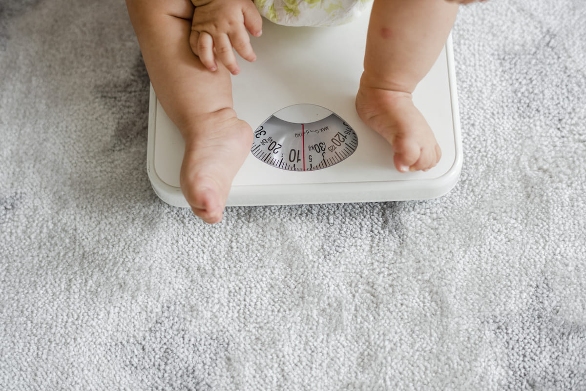 closeup of a baby s legs on a weighing scale 2021 09 04 05 05 13 utc