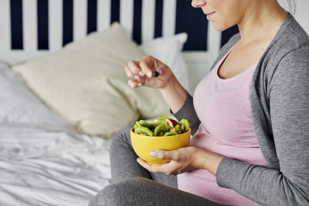 pregnant woman eating healthy fruity snack 2021 08 28 05 51 25 utc