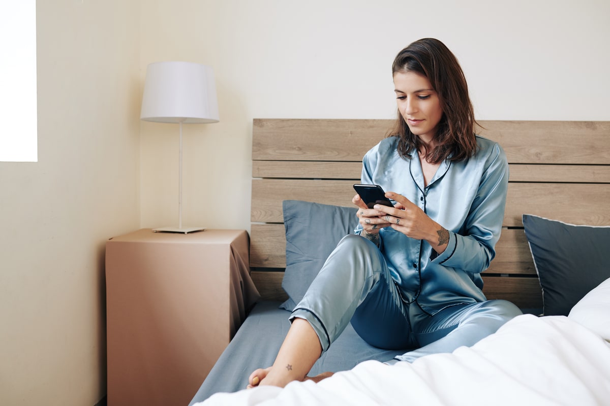 woman in pajamas texting