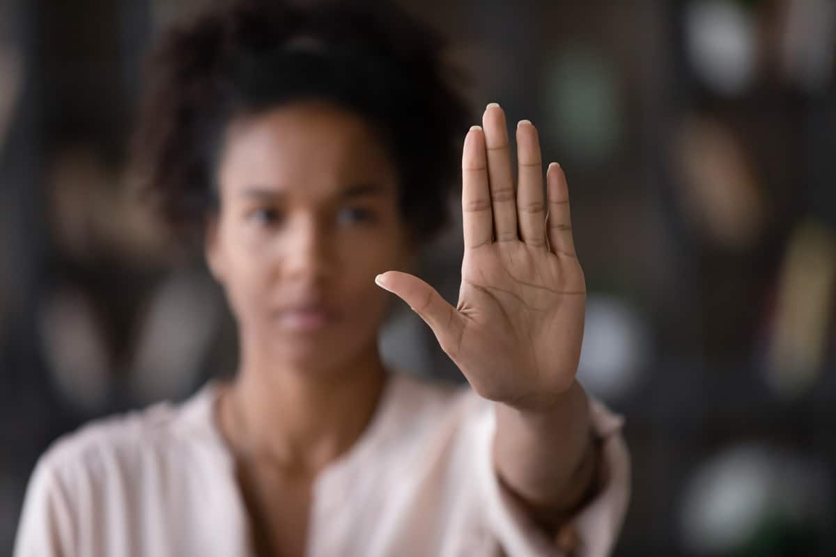 close up african american woman showing stop gesture with hand