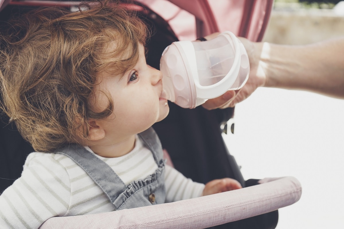 baby drinking water from her bottle