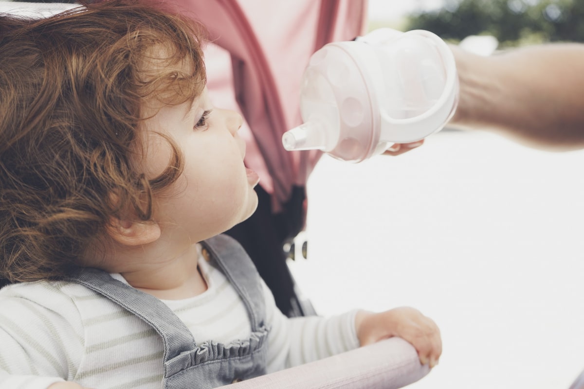 baby drinking water from her bottle