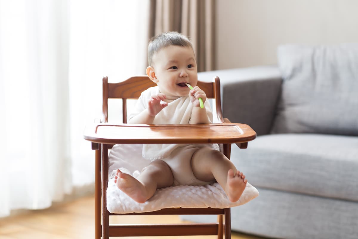 cute chinese baby boy sitting in high chair