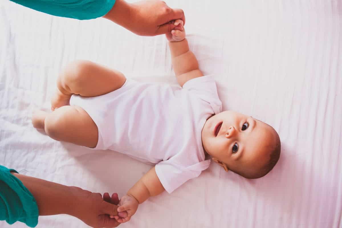 gymnastic with baby top view on the bed 2022 03 10 00 15 46 utc