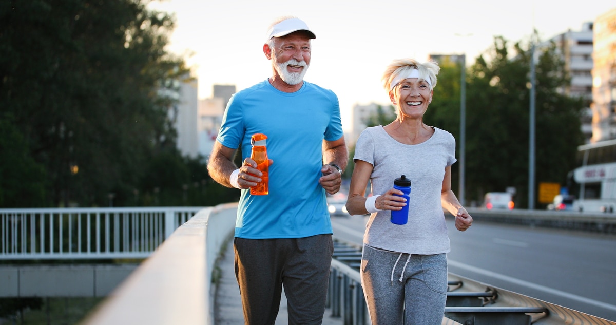 happy mature people couple exercising for healthy life