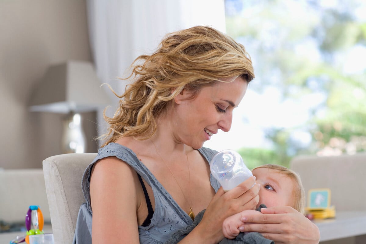 mother bottle feeds baby