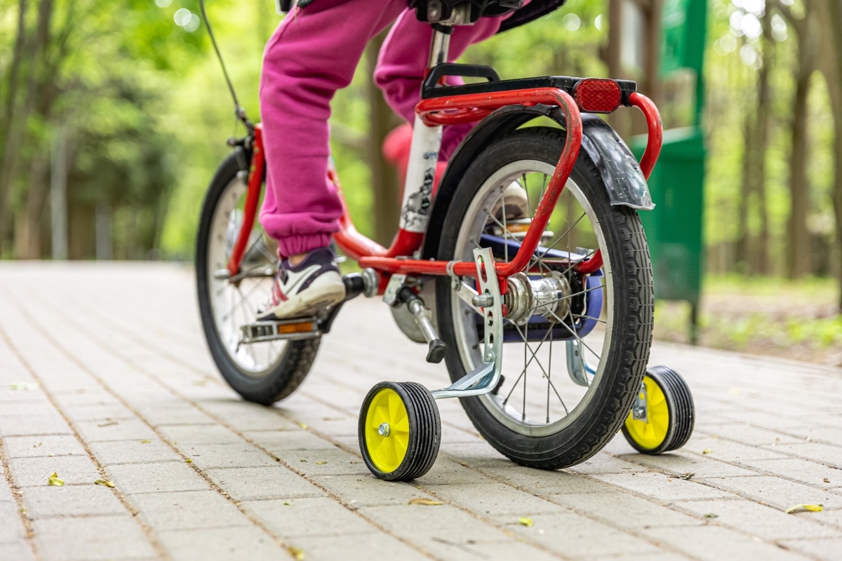 the child is riding a tricycle in the park.