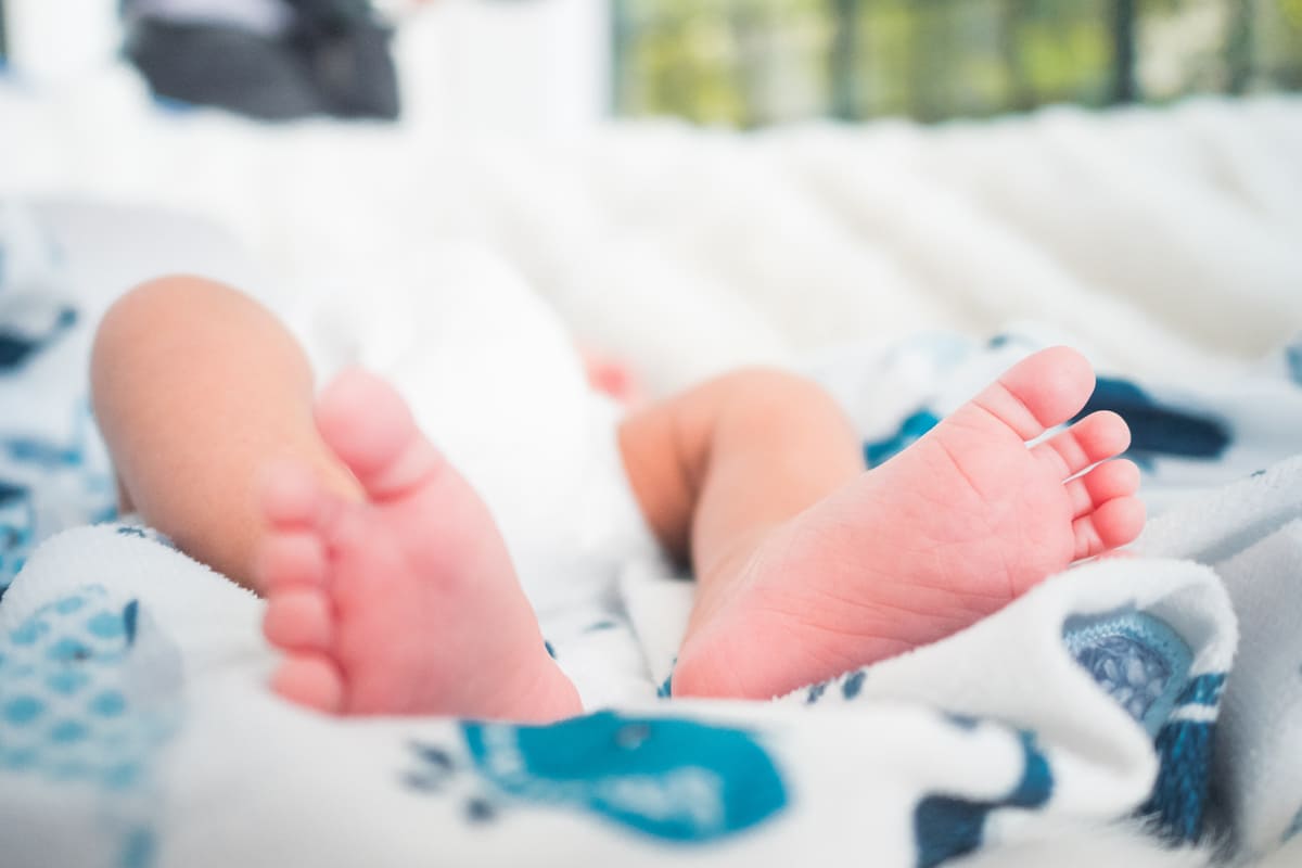 the feet of a new born child who is lying on a sof 2021 09 01 01 11 07 utc