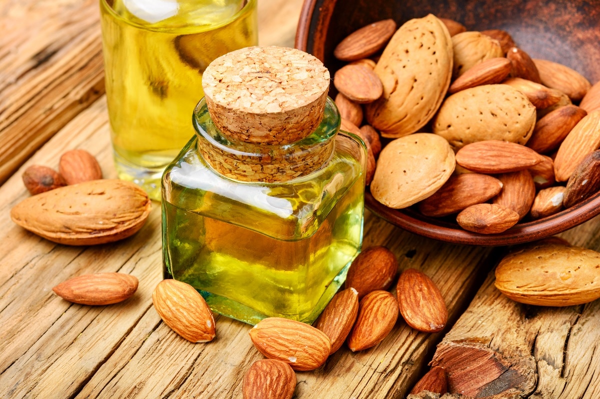 almond oil in bottle and nuts