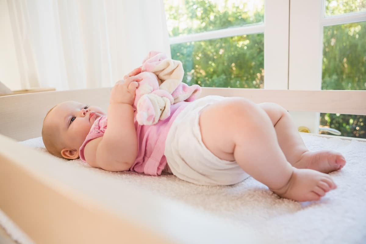 beautiful cute baby girl in her crib at home in bedroom