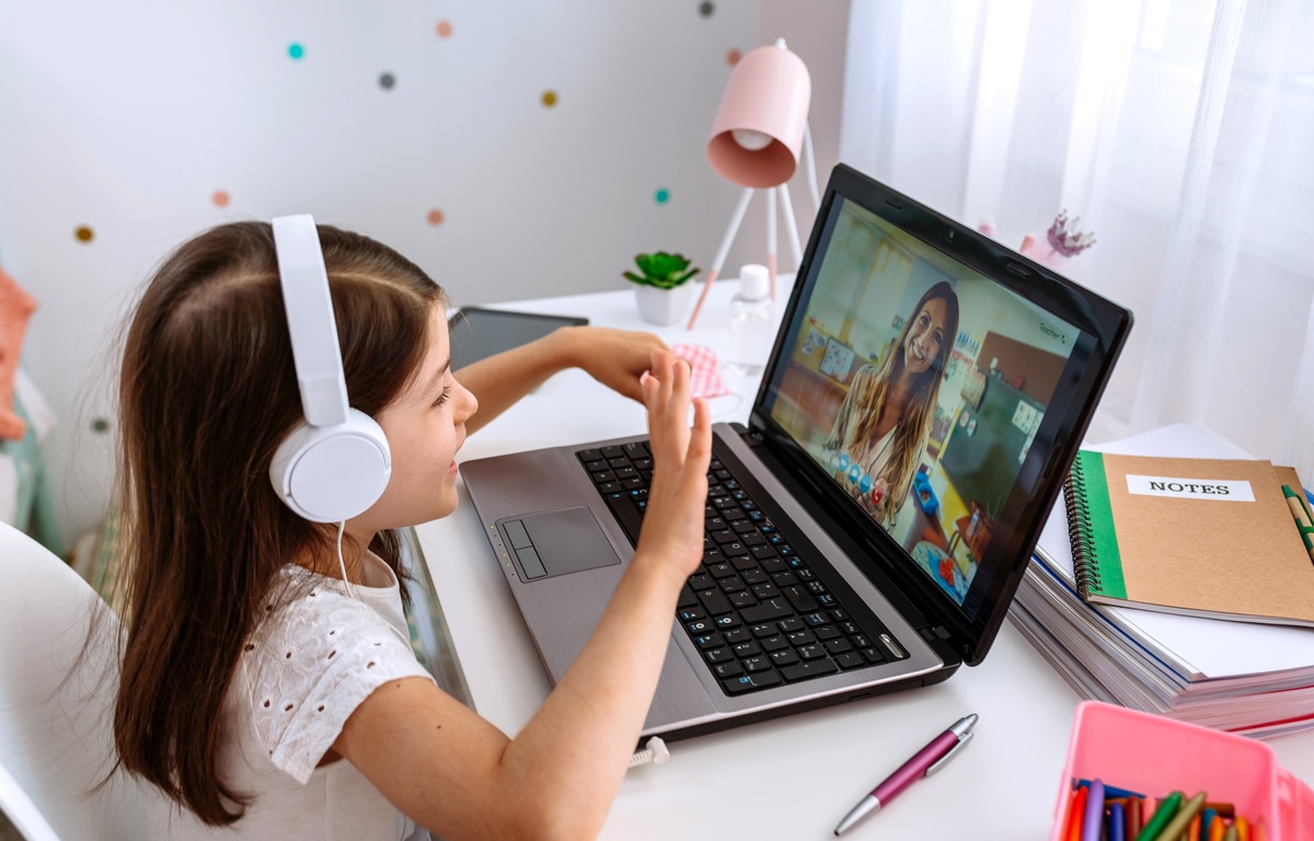 girl watching online class of her teacher