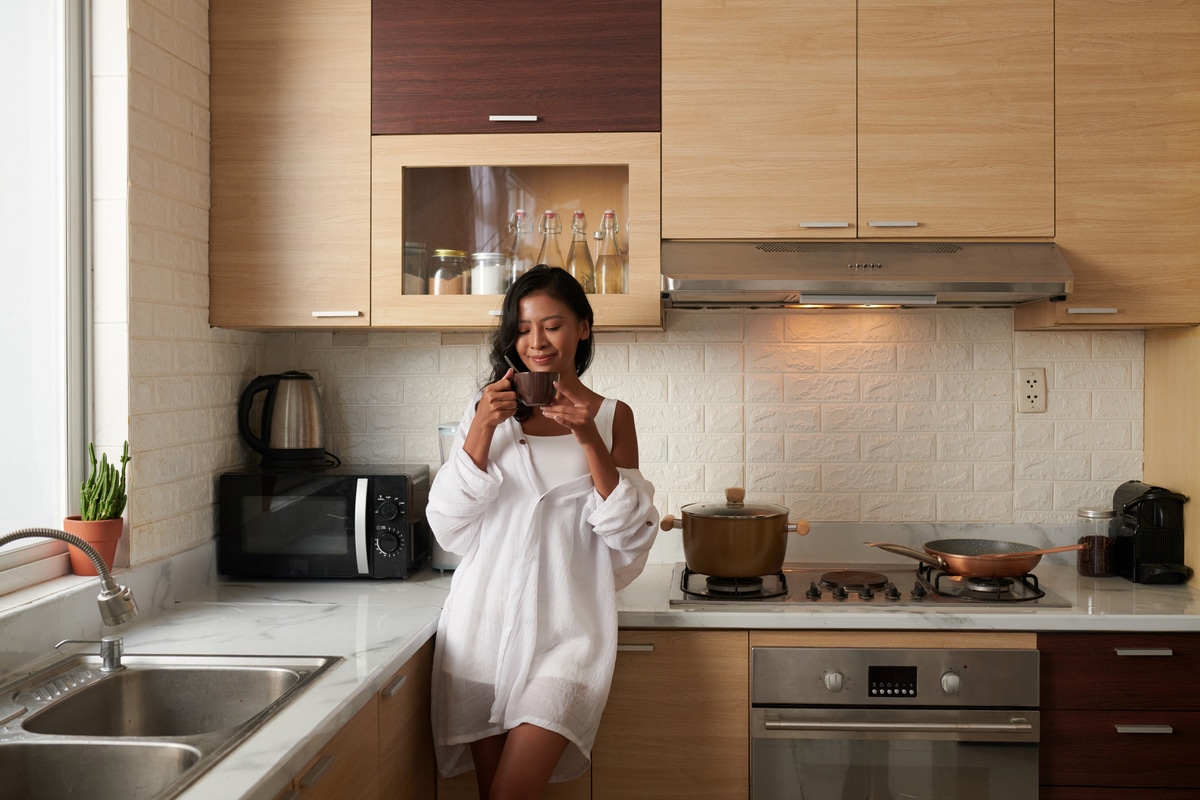 woman drinking coffee in kitchen