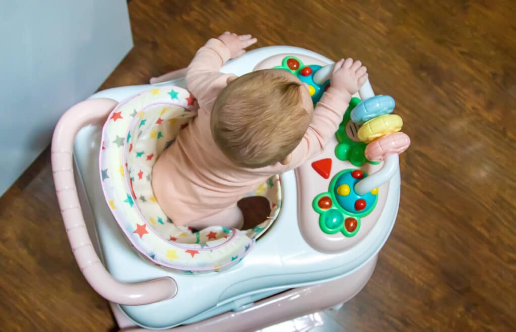 baby is learning to walk on a walker. selective focus.