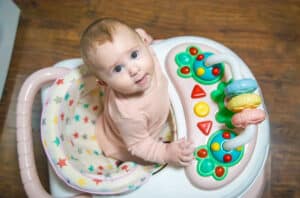 baby is learning to walk on a walker. selective focus.