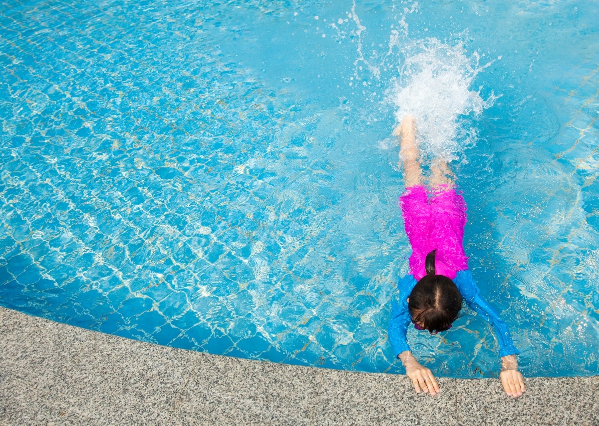 top view of a girl in swimming pool with space