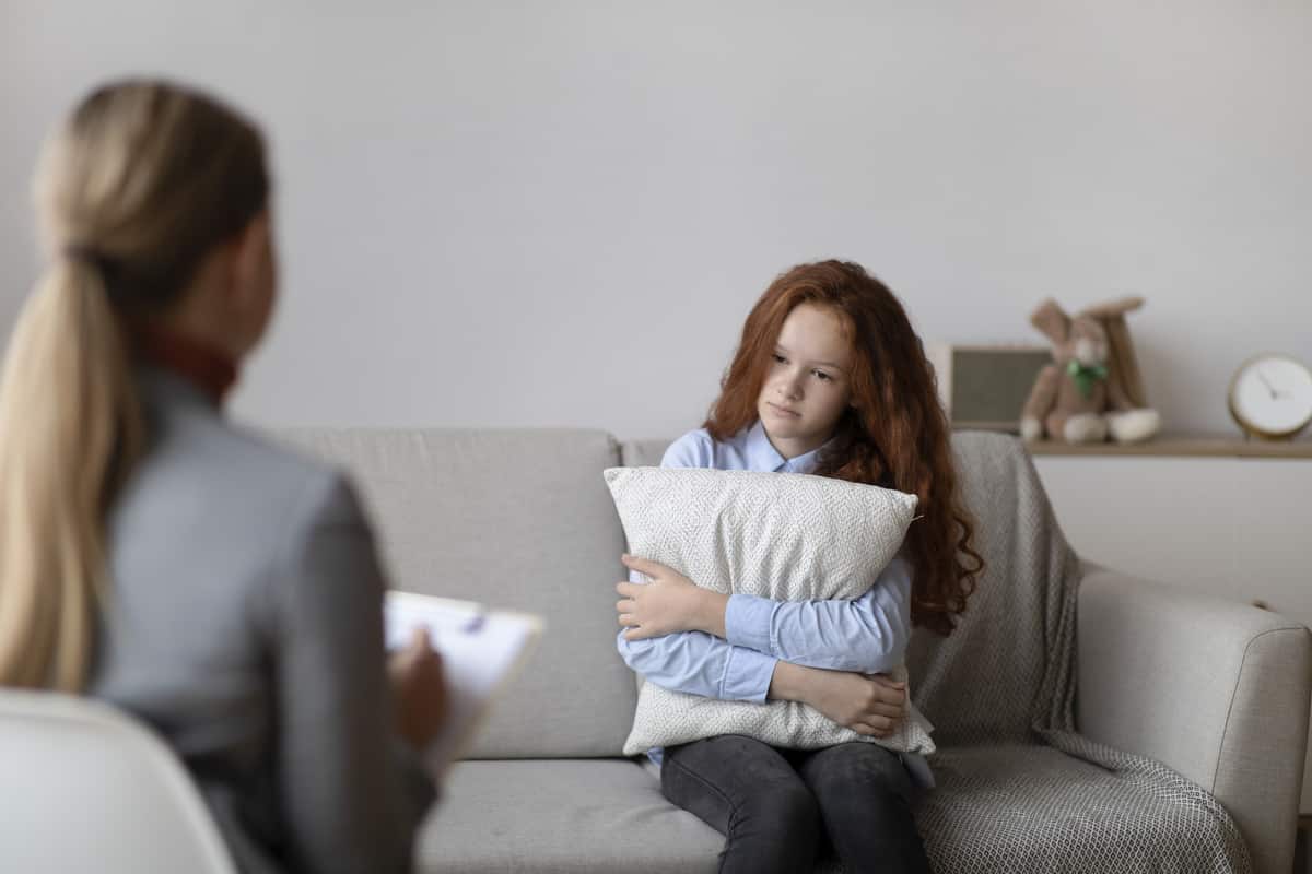 child psychologist. sad teen girl having consultation