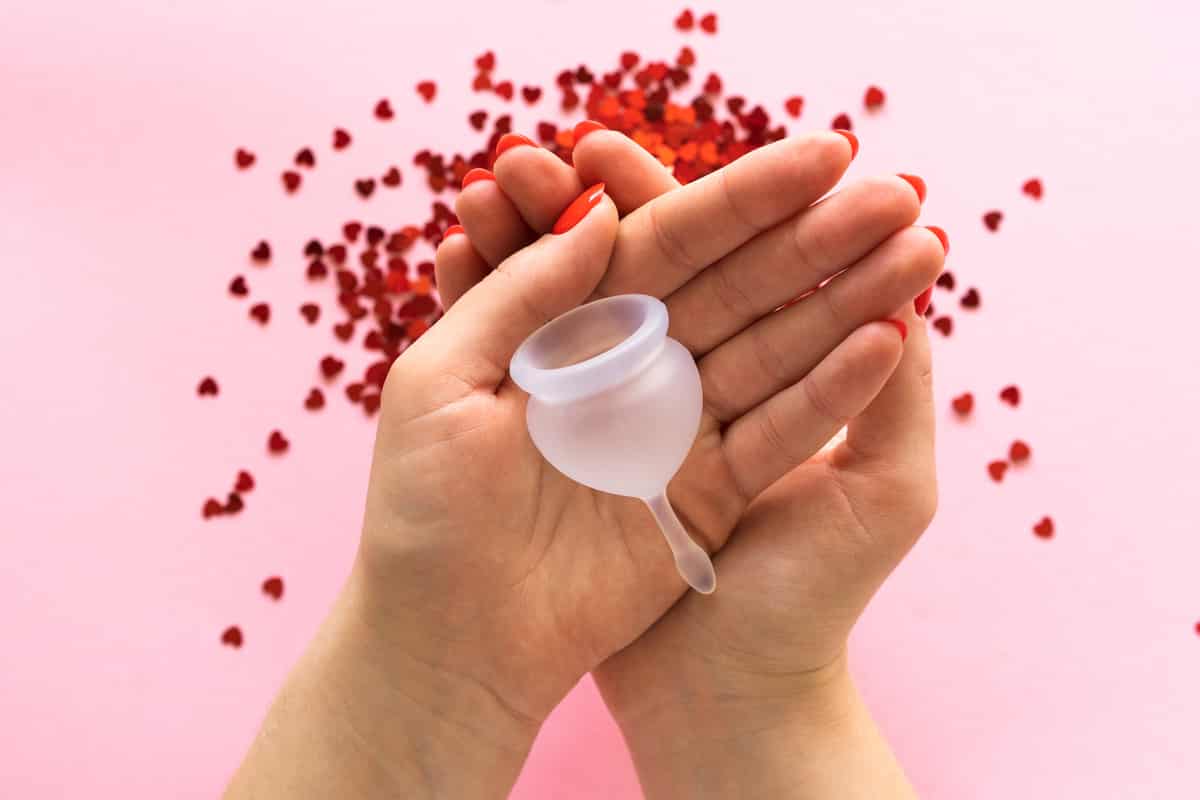 close up of woman hand holding menstrual cup. women's health and alternative hygiene