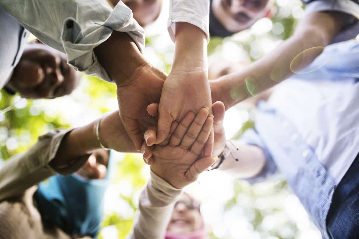 group of diverse youth hands joined