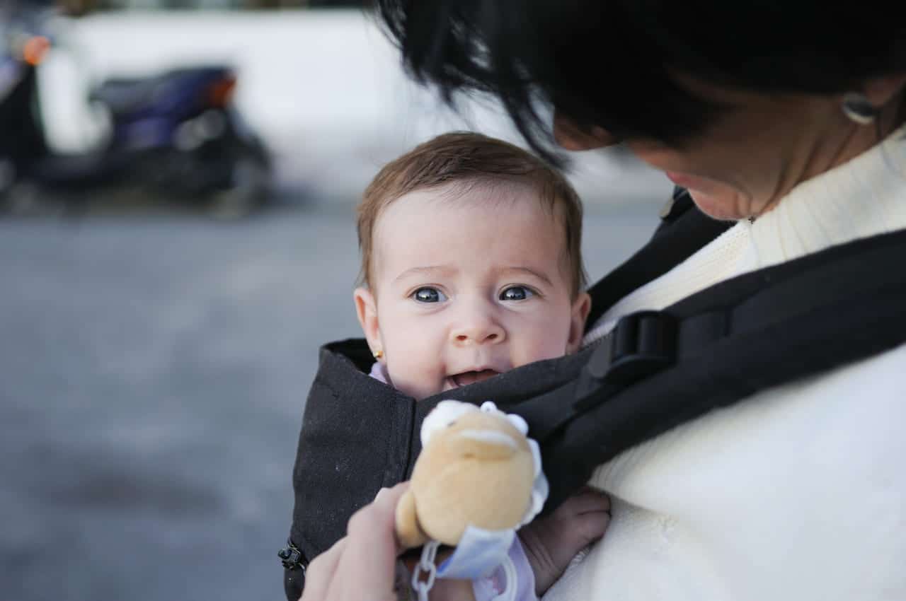 mother carrying her baby girl in a baby carrier 2021 08 26 20 00 05 utc(1)(1)