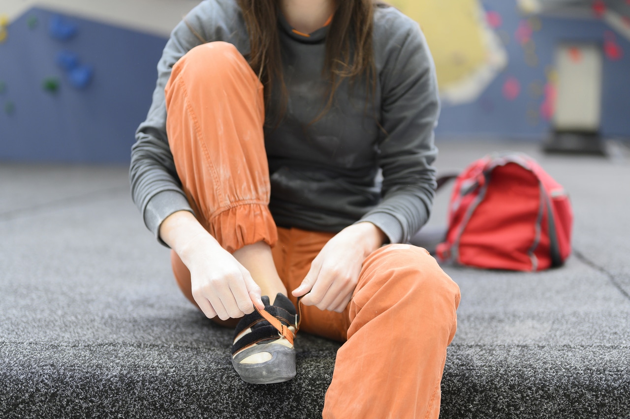 unrecognizable seated female climber removes her r 2022 04 11 15 06 11 utc(1)