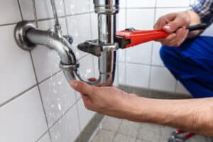 plumber repairing sink pipe leakage