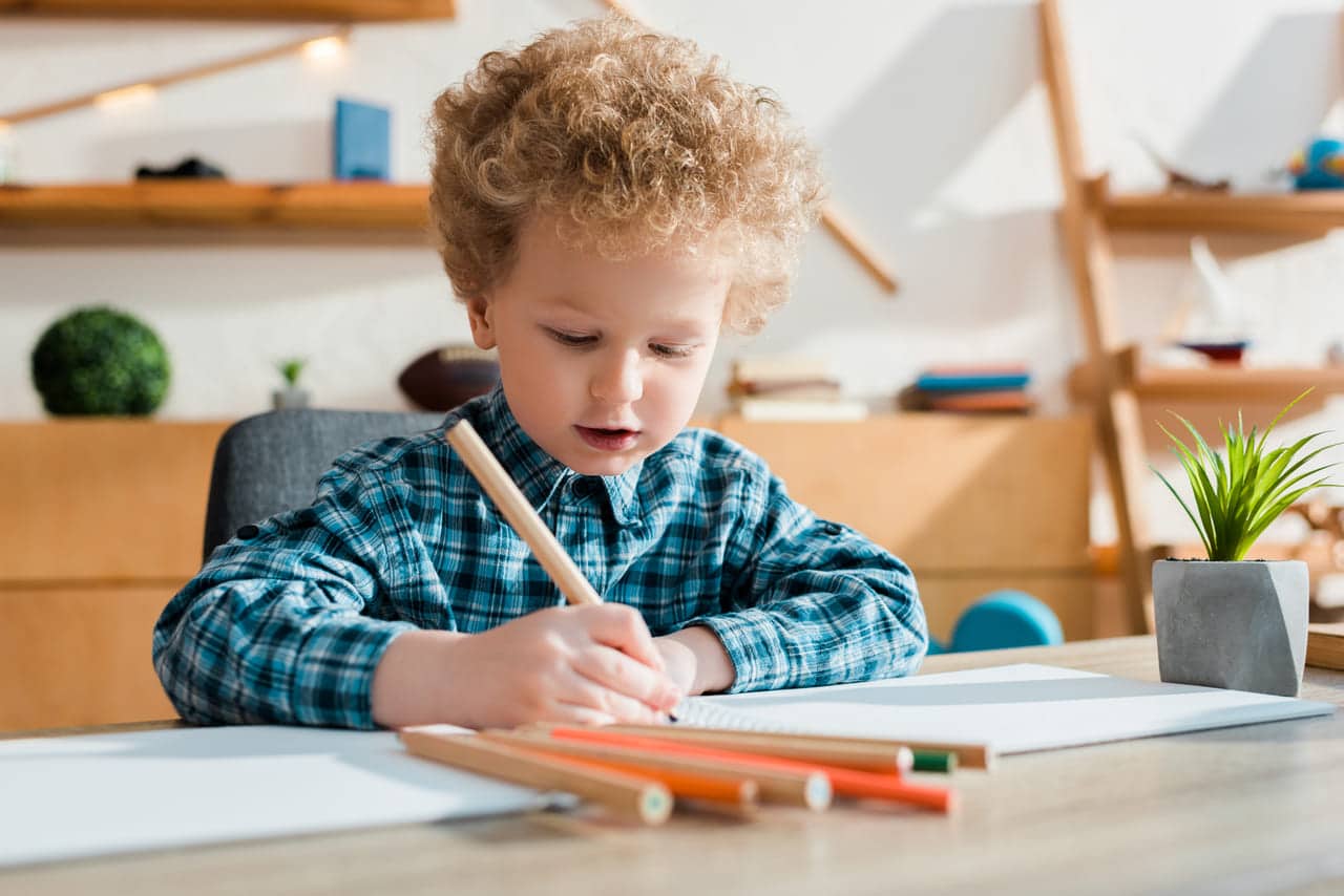 selective focus of kid drawing at desk 2022 04 15 02 38 59 utc