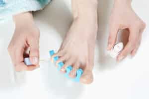 woman painting her toenails, elevated view