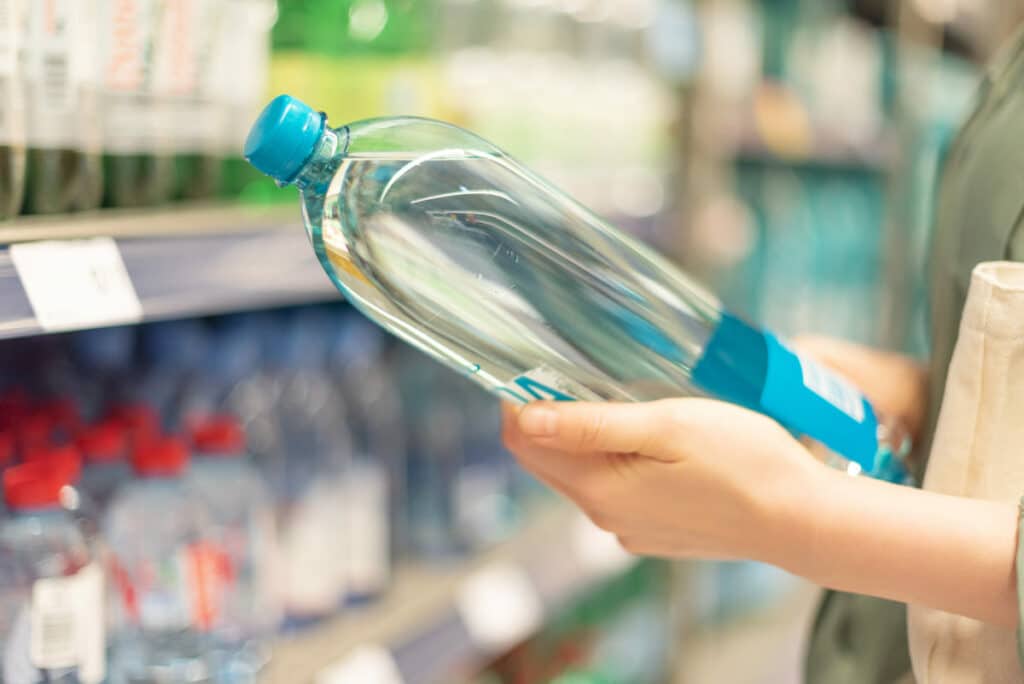 girl choosing bottle of drinking water in grocery 2021 08 26 20 11 39 utc(1)(1)