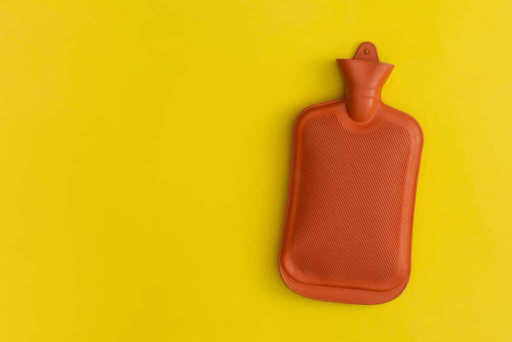 hot water bottle on a yellow background top view 2021 12 09 17 31 48 utc(1)(1)
