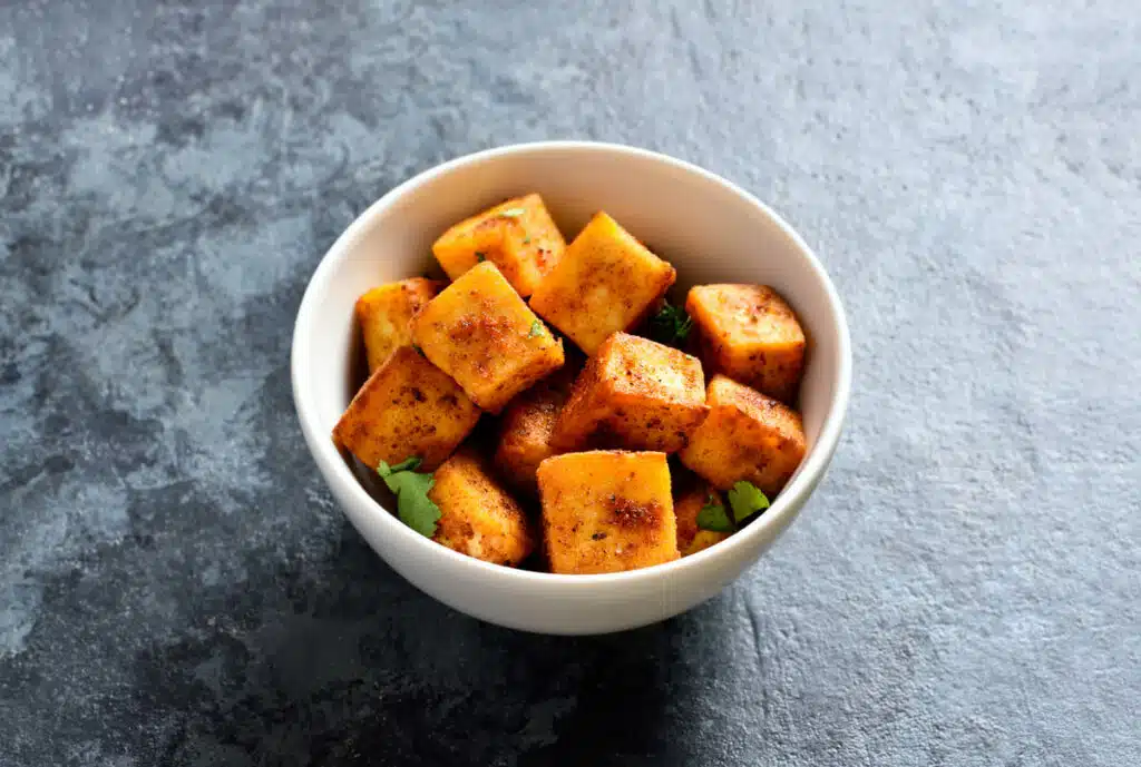 Cooked paneer cubes in a bowl
