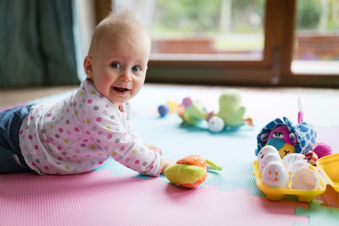 baby toddler playing color toys at home or nursery