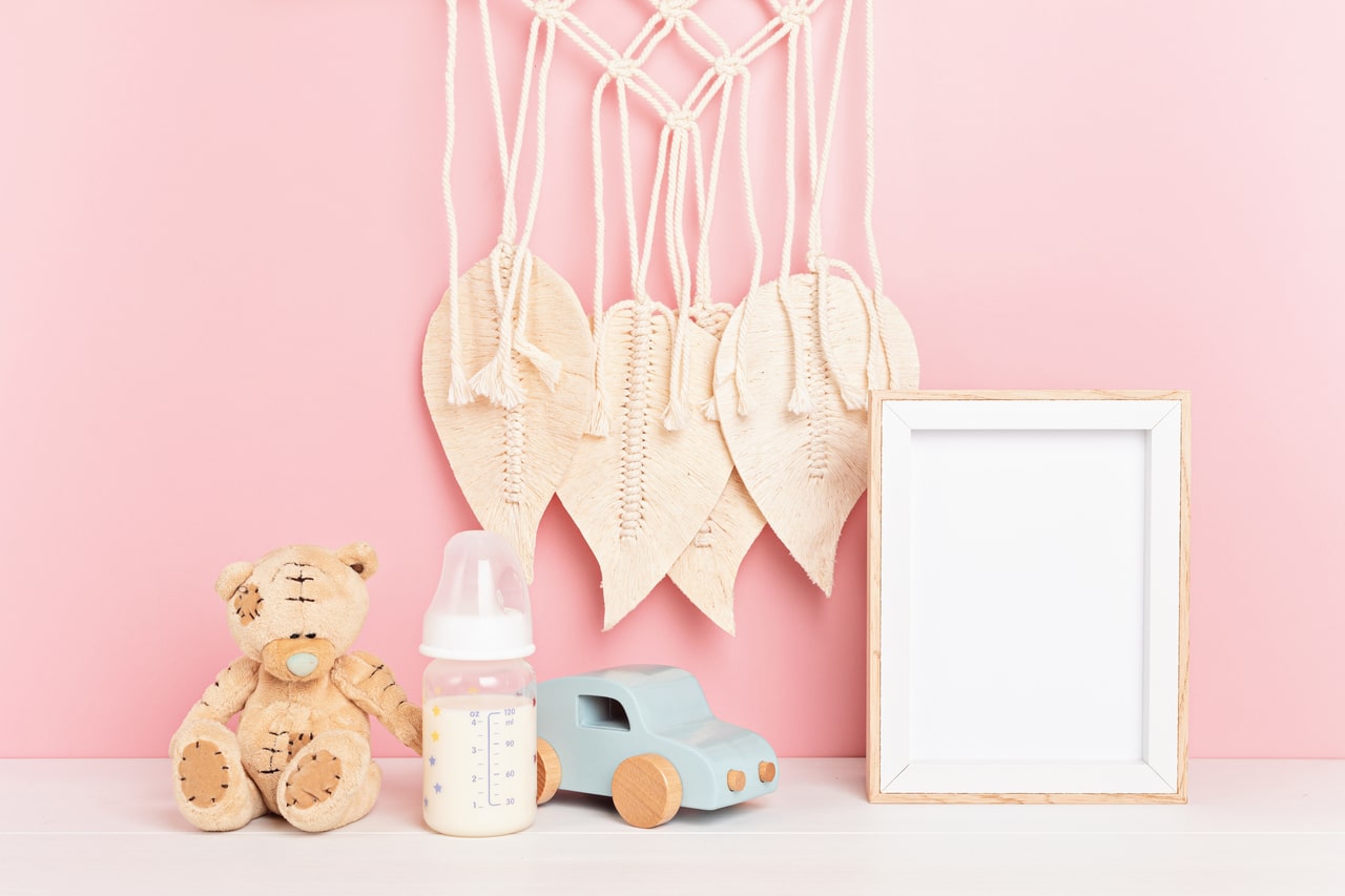 child toys and mockup frame in baby nursery interior.