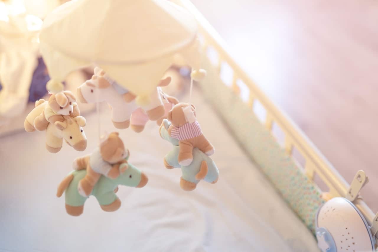 close up baby crib with musical animal mobile at n 2022 11 16 17 04 52 utc