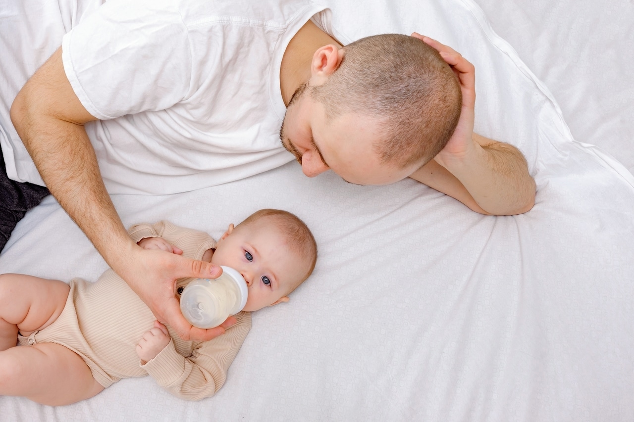 dad and infant child laying on the bed father fee 2022 11 15 12 29 13 utc