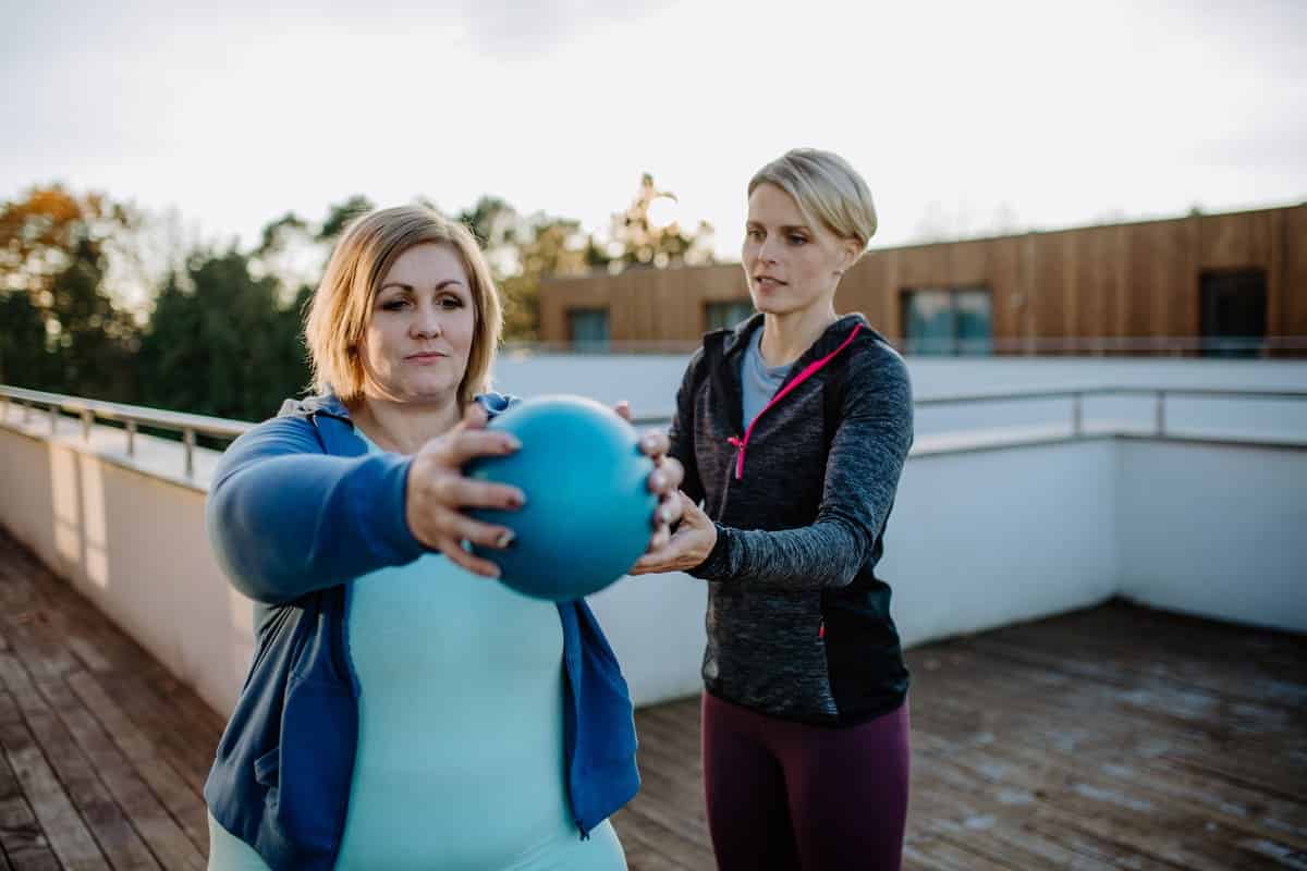 overweight woman holding ball and exercising with 2021 12 14 20 42 05 utc(1)(1)
