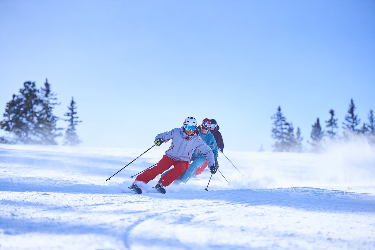 row of male and female skiers skiing down snow cov 2022 03 04 01 53 35 utc