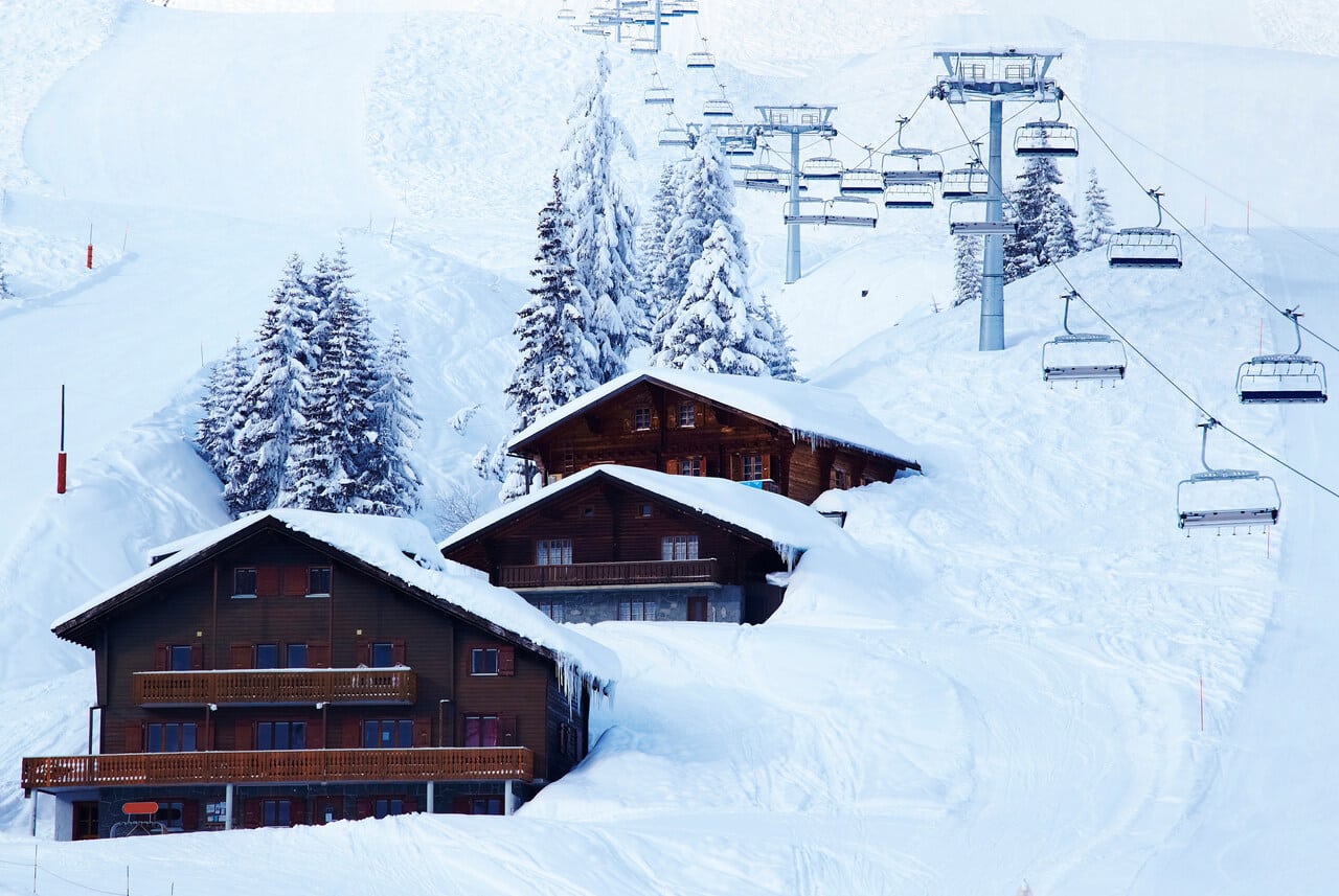 ski lifts over lodges in snow drift