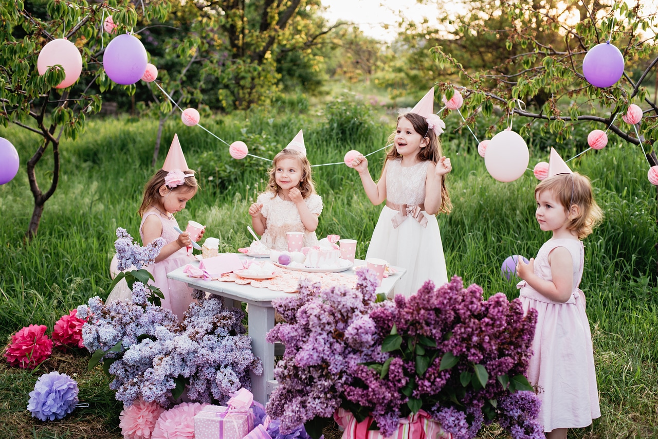 summer outdoor kids birthday party. group of happy children celebrating birthday in park.