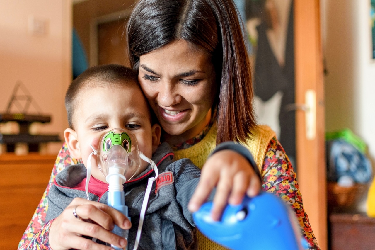 young mother holding toddler boy and helping him b 2022 11 14 18 02 05 utc