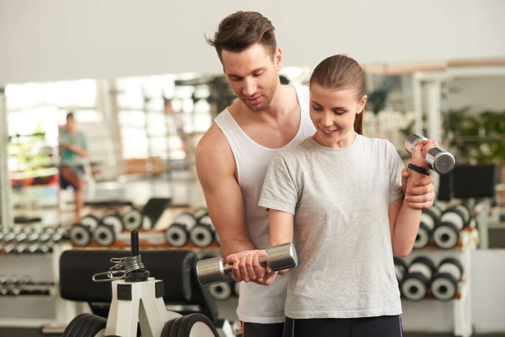 young woman lifting dumbbells with personal traine 2021 09 03 17 21 48 utc(1)(1)