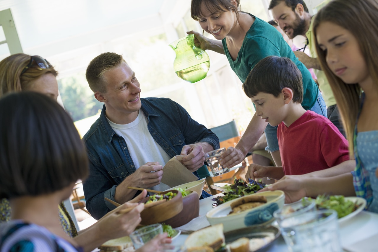 lifestyle in the country,a family party around a table in a cafe. adults and children.