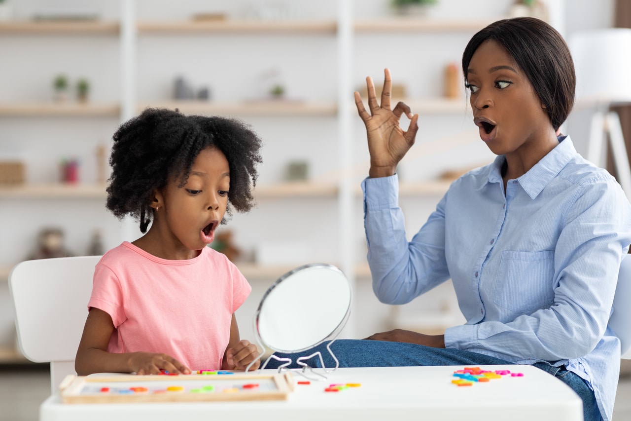 pretty little black girl attending speech therapy session