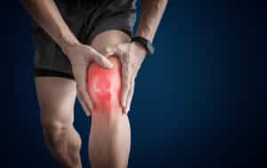 joint pain, arthritis and tendon problems. a man touching nee at
